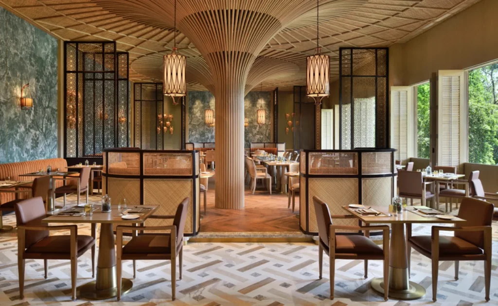 elegant interior of a cafe chain in Koramangala, Bangalore, is digitally rendered with partitioned seating, stylish lighting, and a tree-like central pillar. This detailed visual content could have been created by Aspire Digital Solutions to help with a promotional campaign.