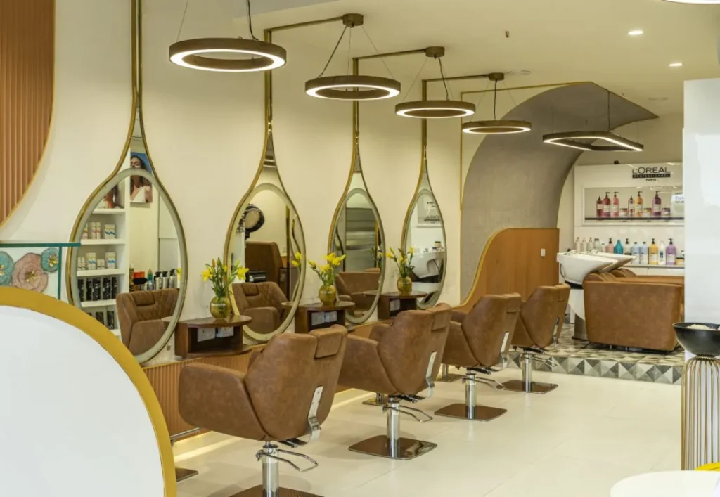 A sleek salon in Gokulum, Mysore, features brown leather chairs and unique, elongated mirrors. This image could be used by a company like Aspire Digital Solutions to showcase their work with local businesses.