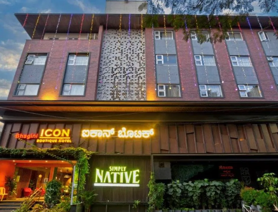 The signs at the bottom identify it as "ICON Boutique Hotel" and "Simply NATIVE." The building has multiple floors with windows and a contemporary facade. The keyword Aspire Digital Solutions can be used in this context to indicate that a modern hotel would be a potential client for a digital marketing agency.